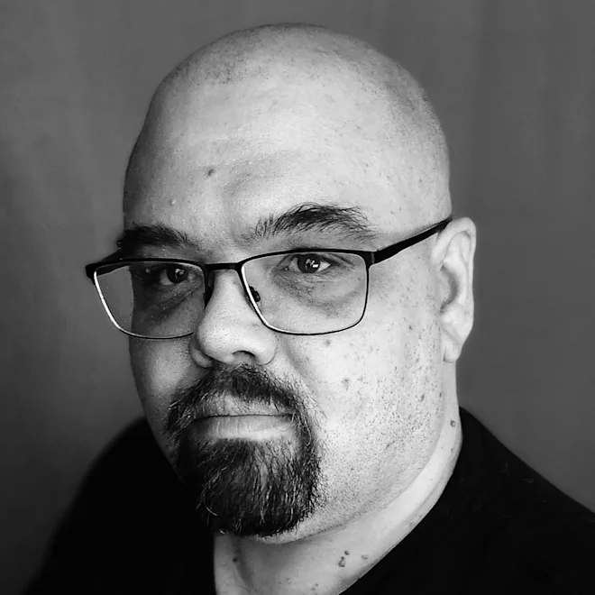 A headshot of author J.E. Teitsworth